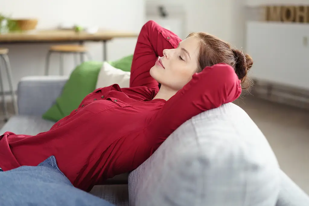 Junge Frau entspannt auf einem Sofa